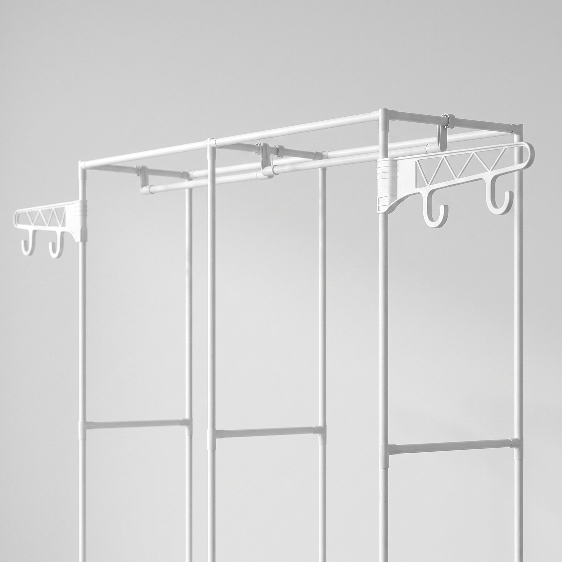 Close-up of the white garment rack's rods and top side hooks
