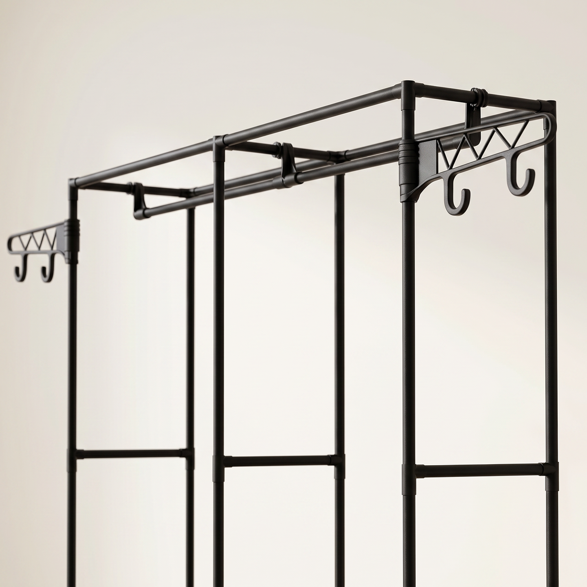 Close-up of the black garment rack's rods and top side hooks